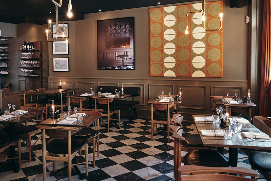 Tables inside Restaurant Palægade in Copenhagen. Winner of Byens Bedste 2022 - Best Danish Open-faced sandwiches. 
