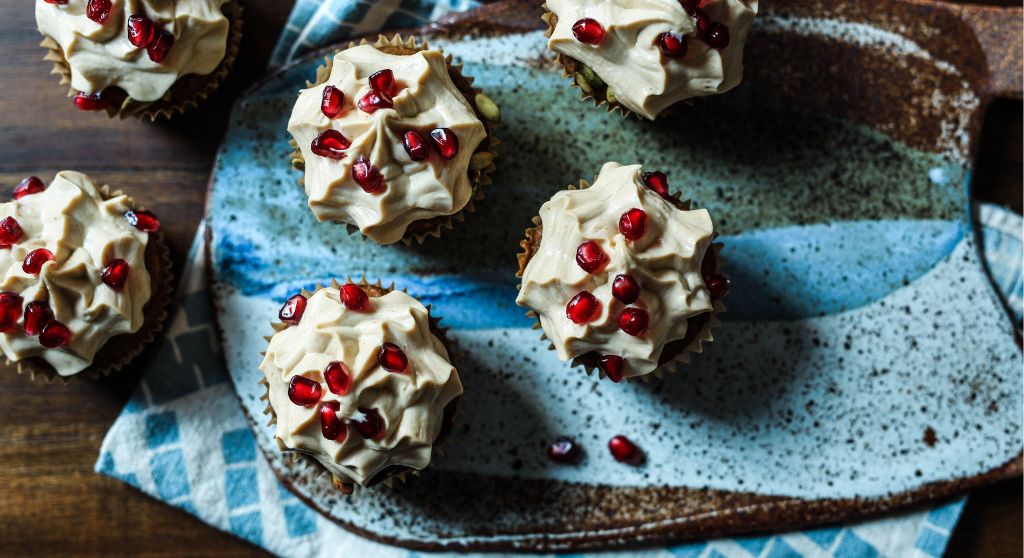 Christms cupcakes decorated with frosting and pomegranate 