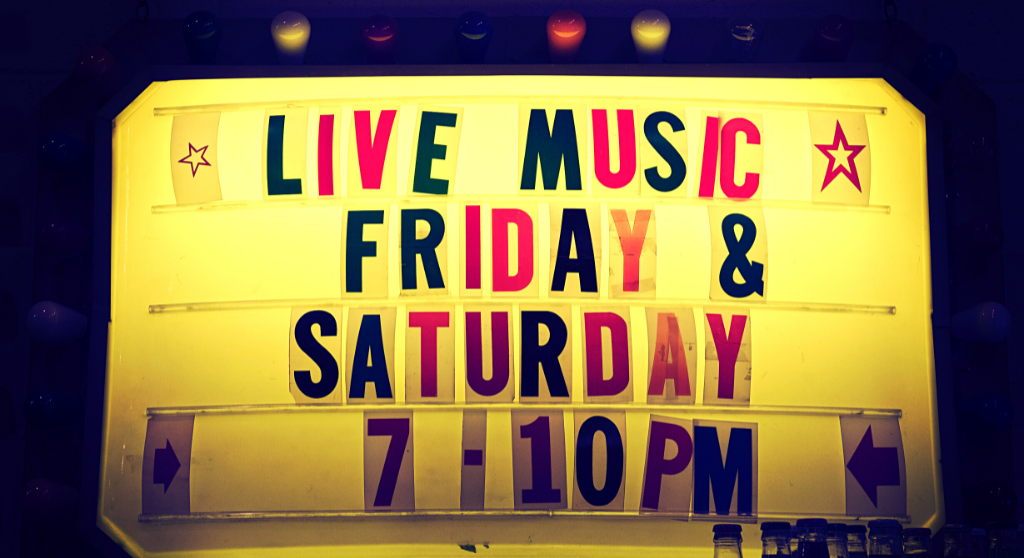 A light sign with the text "Live music Friday & Saturday 7-10 PM."